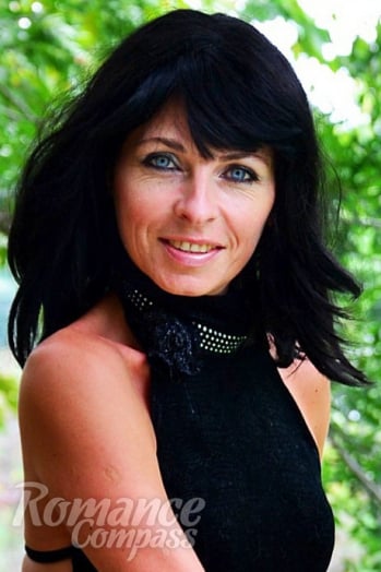 Ukrainian girl Anna,55 years old with blue eyes and black hair.