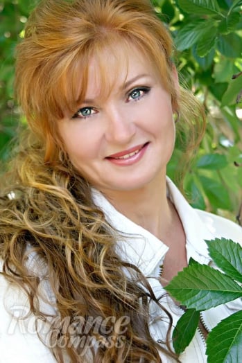 Ukrainian girl Elena,57 years old with blue eyes and auburn hair.