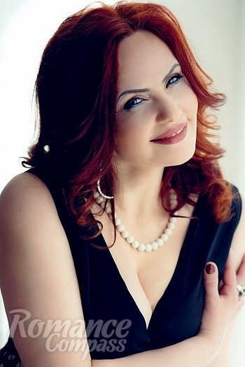 Ukrainian mail order bride Anna from Kiev with red hair and green eye color - image 1