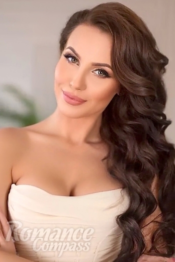 Ukrainian mail order bride Valentina from Kyiv with black hair and green eye color - image 1