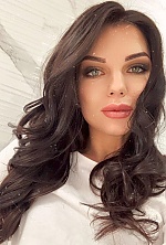 Ukrainian mail order bride Anastasia from Kyiv with black hair and green eye color - image 2