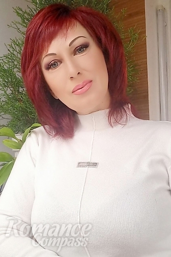 Ukrainian mail order bride Oksana from Nikolaev with red hair and blue eye color - image 1