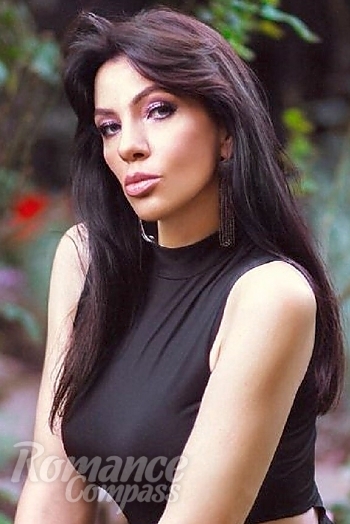 Ukrainian mail order bride Ganna from Kiev with black hair and green eye color - image 1