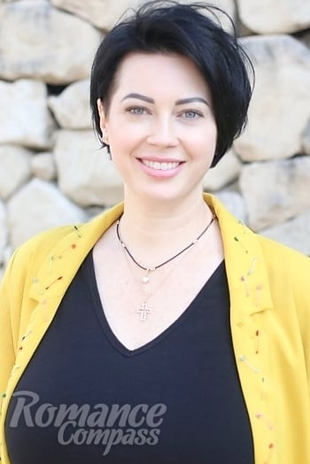 Ukrainian mail order bride Olga from Alicante with black hair and green eye color - image 1
