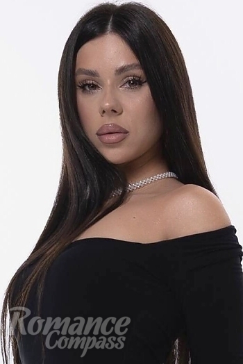 Ukrainian mail order bride Oksana from London with black hair and green eye color - image 1