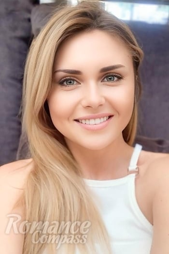 Ukrainian mail order bride Oksana from Costești with blonde hair and hazel eye color - image 1